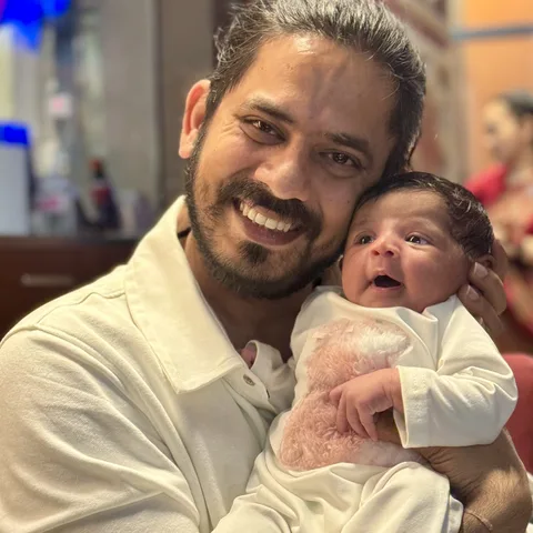 Aditya, founder of Dads Journey, holding his newborn daughter